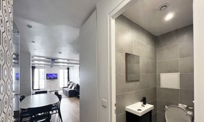 A modern interior with a dining area, a living room, and a bathroom. - Urban Flat 14 - Charming 3 BDR Flat in Paris (París)