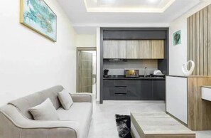 Family Apartment, Balcony, City View | Private kitchenette | Fridge, microwave, oven, stovetop