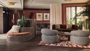 A modern living room with a round seating area, a sofa, and a coffee table.