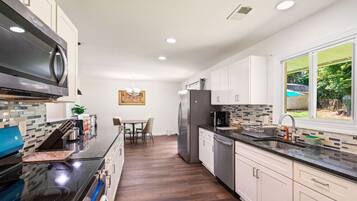 Dishwasher, coffee/tea maker, cookware/dishes/utensils, dining tables