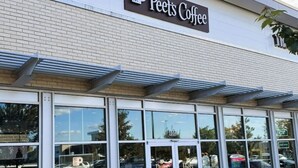 A Peet's Coffee storefront with large glass windows and a clear sign above the entrance.