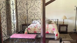 A bedroom with a bed, a chair, a table, and a colorful rug. - w Peaceful 1BR Surrounded by Nature in Huaraz (Yungar)