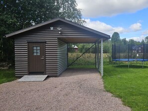 A small cabin with a door and a covered porch area.