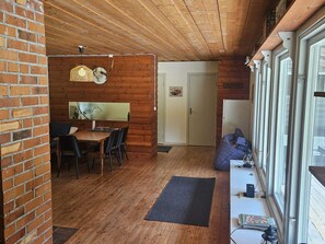 A wooden interior with a dining area, a door with a 'Mustang' sign, and a window with blinds. - 4 Star Holiday Home in By Kyrkby (By Kyrkby)