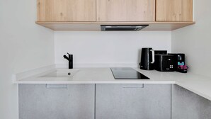 A kitchen with a white countertop, a sink, a coffee maker, and a toaster. - Beautiful Cozy Apartment - 1 Bdr/4p - Gare de Lyon / AC (Paris)