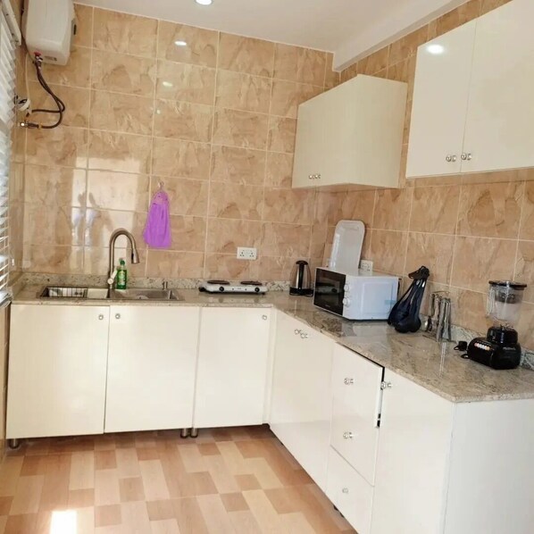 Economy Apartment, Balcony, City View | Private kitchen | Fridge, microwave, oven, stovetop - Residex Apartment (Abuja)