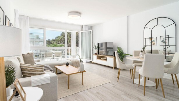 A modern living room with a sofa, coffee table, and dining area. - RI B2a- Relaxed Modern Flat in Benahavis (Benahavis)