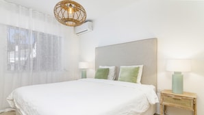 A bedroom with a large bed, two bedside lamps, a woven light fixture, and a window with sheer curtains. - Ags48b- Great Location Close to Puerto Banus Casa (Marbella)