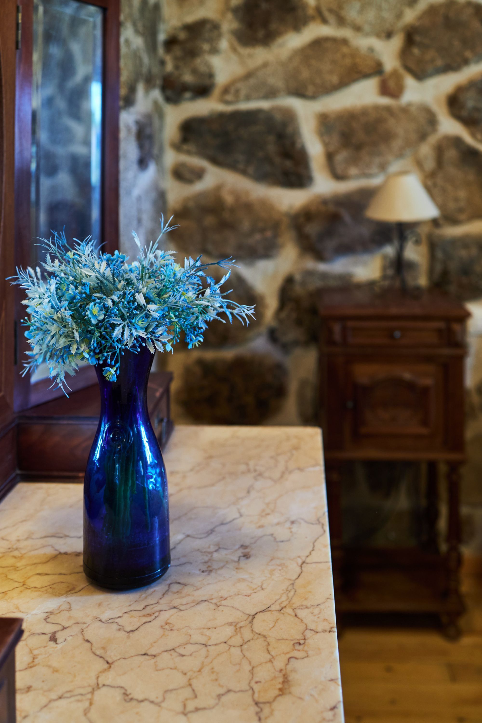 Eine Vase mit Blumen auf einer Marmorplatte.