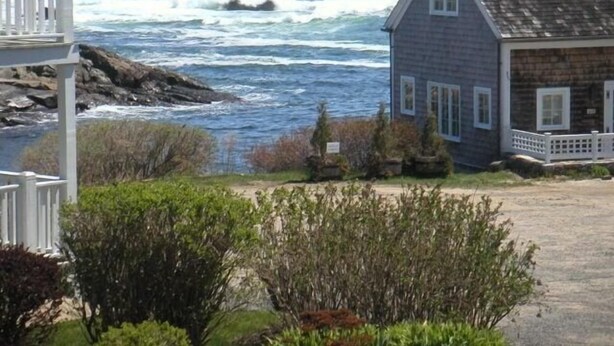 A coastal house with a porch, a view of the ocean, and a rocky shoreline. - Perkins Cove Gem - Q934 (Ogunquit)