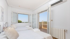 A bedroom with two beds, a radiator, and a balcony with a view. - Real Dream Villa by Fidalsa (Jacarilla)