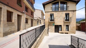 A two-story building with a stone facade and a balcony. - Wine Escape by Fidalsa (Villabuena de Alava)