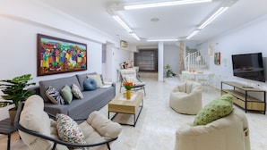 A modern living room with a grey sofa, beige armchairs, a coffee table, and a TV. - Coral Seashell Ground Floor by Fidalsa (Guardamar del Segura)