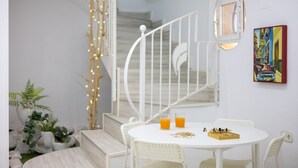 A white dining area with a table, chairs, and a chessboard. - Coral Seashell Ground Floor by Fidalsa (Guardamar del Segura)