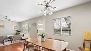 A dining area with a wooden table and chairs, a ceiling fan, and a potted plant. - Edgemont in Scottsdale (Scottsdale)
