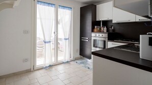 A kitchen with a stove, oven, and cabinets.
