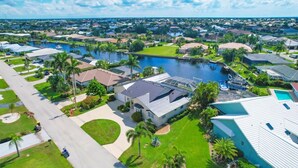 An aerial view of a residential area with houses, a marina, and a large body of water. - BVC265 Summary:<br>Punta (Punta Gorda)