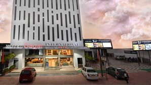 A modern hotel with a grid-like facade, a bar, and a parking area. - HOTEL SAGAR INTERNATIONAL (Durg)