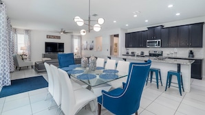 A modern kitchen with dark cabinets, a microwave, and a stove.