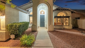 A well-lit house with a covered entrance, a visible door, and a pathway leading to the front. - Pool| Lake Views |Private Dock |Paddleboat |Oasis (Glendale)