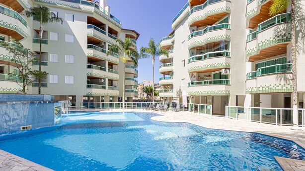 A swimming pool surrounded by multi-story buildings with balconies and a tiled exterior. - Apart w Barbecue Grill 180m From the Beach Cgb0035 (Ubatuba)