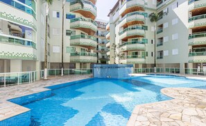 A swimming pool surrounded by multi-story residential buildings with balconies. - Apart w Barbecue Grill 180m From the Beach Cgb0035 (Ubatuba)