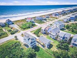 A coastal residential area with houses, a beach, and a clear sky. - Lovin' Lowe Tide | Pet-Friendly, Elevator + Ocean Views (North Topsail Beach)