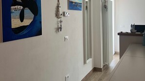 A modern interior with a kitchen area, a dining space, and a hallway. - Rebecca s Portovenere Collection (Portovenere)