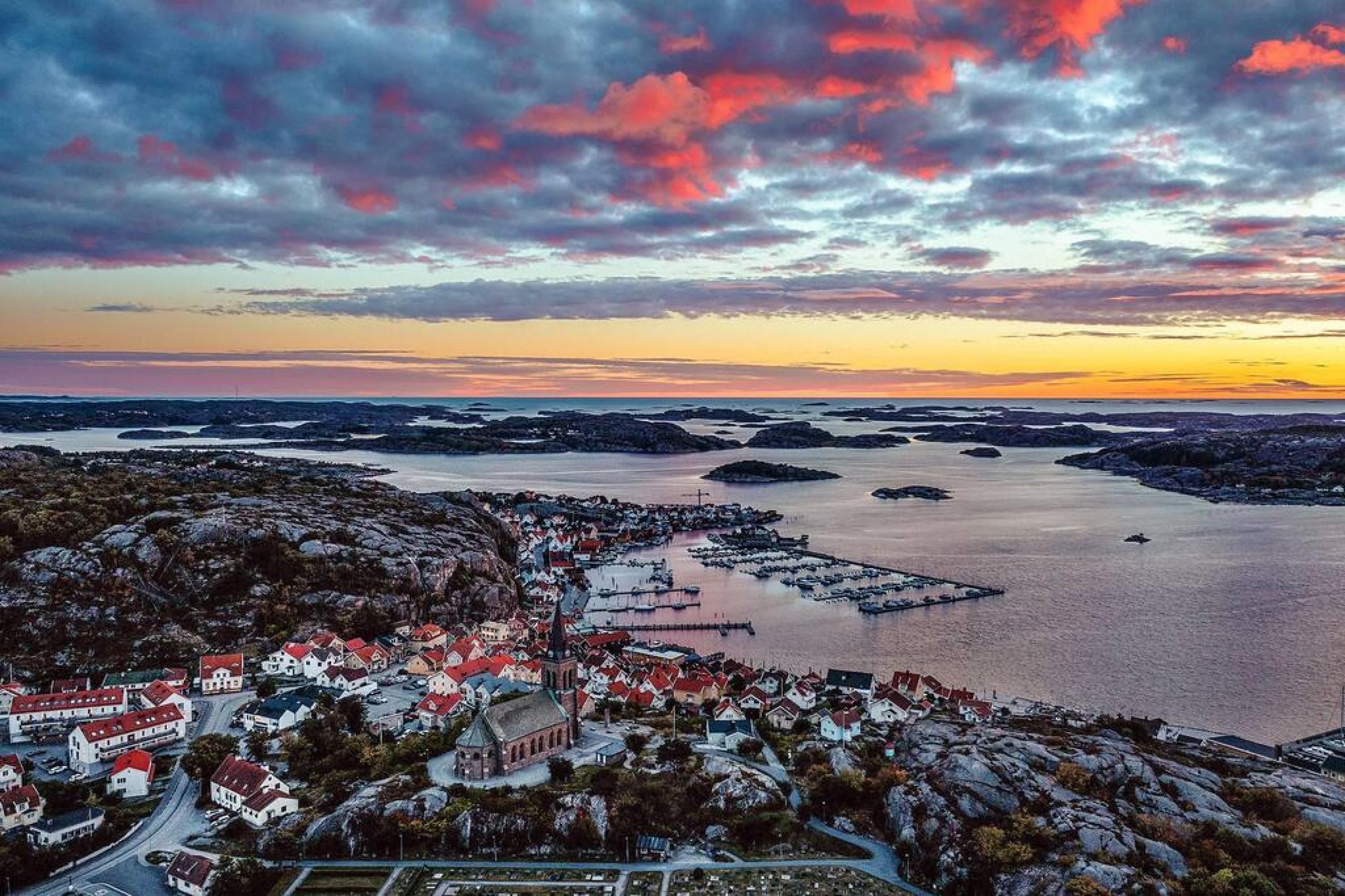 A coastal town with a church, houses, and a marina.