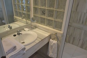 A bathroom with a white sink, mirror, and glass block window. - 3 Bed Excellent and Quiet Location F-4 (Marbella)