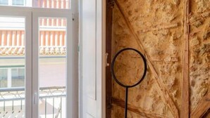 A room with a wooden door, a round mirror, and a view of a balcony with railings. - Old Town Chiado Balcony Aircon by LD Apartments (Lisbon)