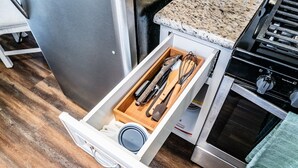 A kitchen with a stainless steel refrigerator, a granite countertop, and a built-in oven. - Lux - Charming San Marcos 2BR Patio Pet-friendly (San Marcos)