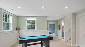 A pool table in a room with white walls and a window. - Destined for Relaxation (Saugatuck)
