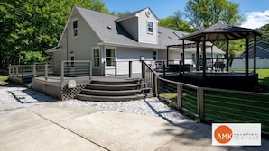 A two-story house with a covered porch and a small gazebo. - All Decked Out Farmhouse - Game Room Nearby Beach (Holland)