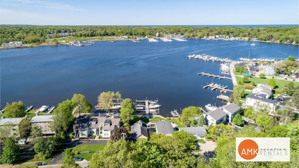 A marina with boats docked, surrounded by residential buildings and greenery. - Charming Bayview - Downtown Condo With Pool (Saugatuck)