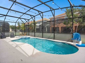 A covered outdoor swimming pool with a clear view of the surrounding neighborhood.
