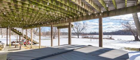 A covered outdoor seating area with a view of a snowy landscape.