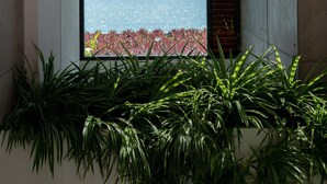 A modern interior with a large window overlooking a body of water and mountains. - Solaris 3-bedroom Beachfront Villa in Koh Samui (Koh Samui)