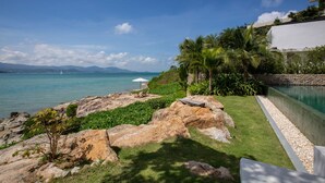 A coastal property with a swimming pool, rocky terrain, and a view of the sea. - Syrah 3-bedroom Beachfront Villa in Koh Samui (Koh Samui)