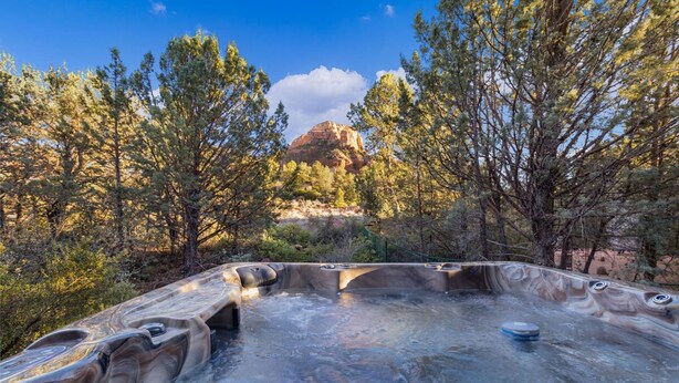 A hot tub surrounded by trees and a mountain in the background. - Mammoth Rock Oasis-1 bd 1ba Hot Tub Free Pets (Sedona)