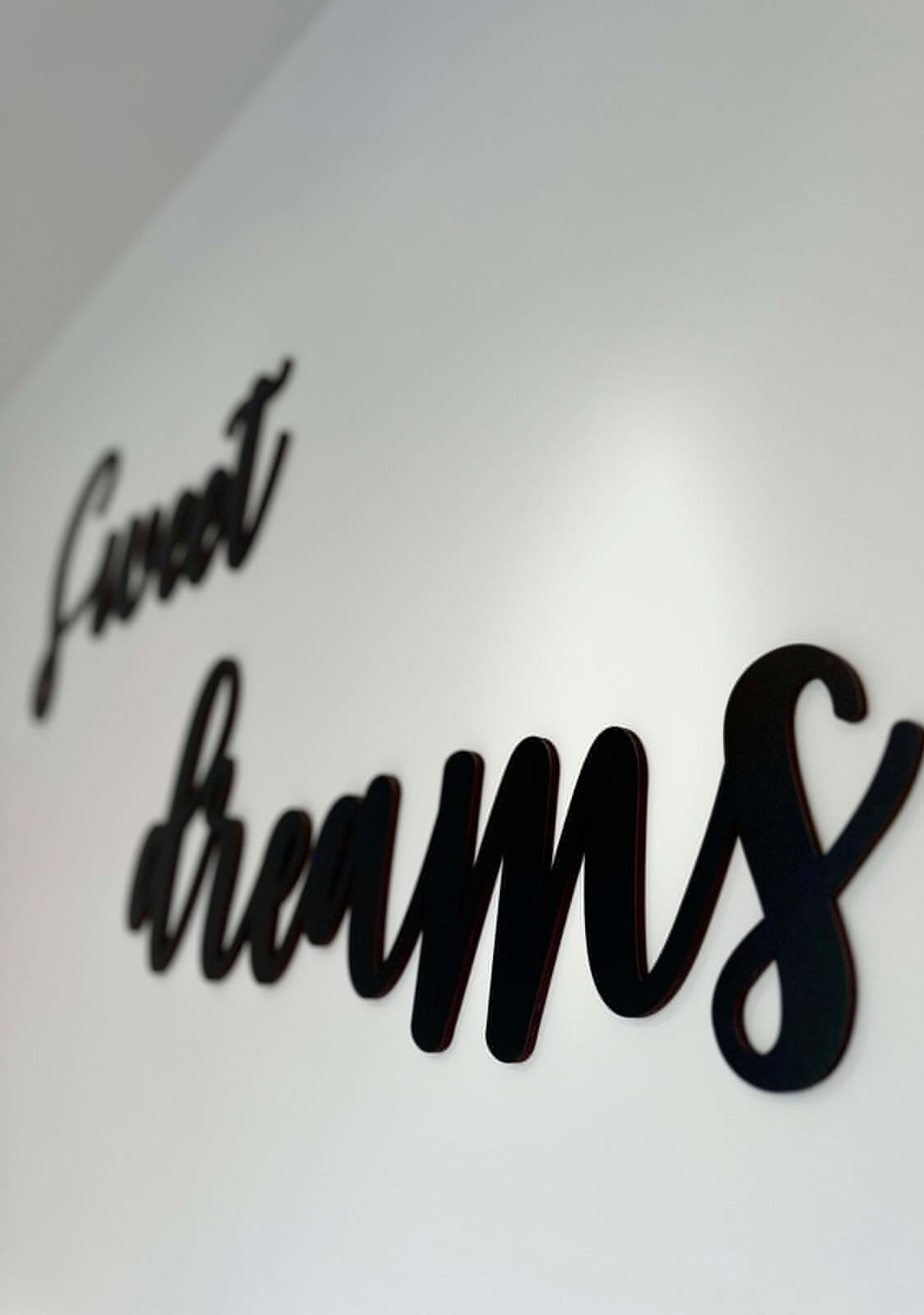 A wall with the text "Secret Dreams" in a stylized font.