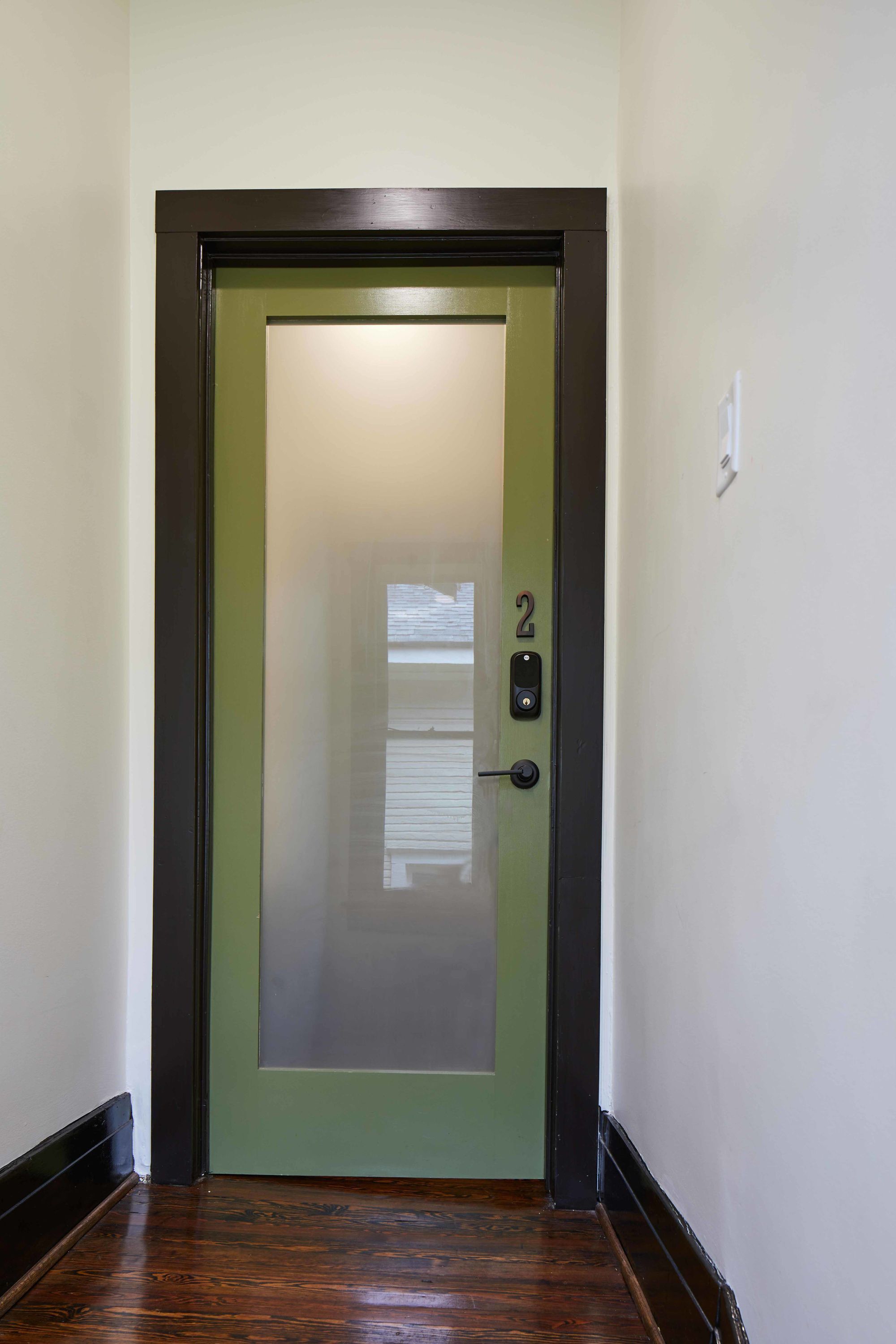 A door with a frosted glass panel and a number '2' on the door frame.