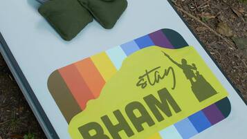 A table with a sign that reads "stay BHAM" and a hole in the center.