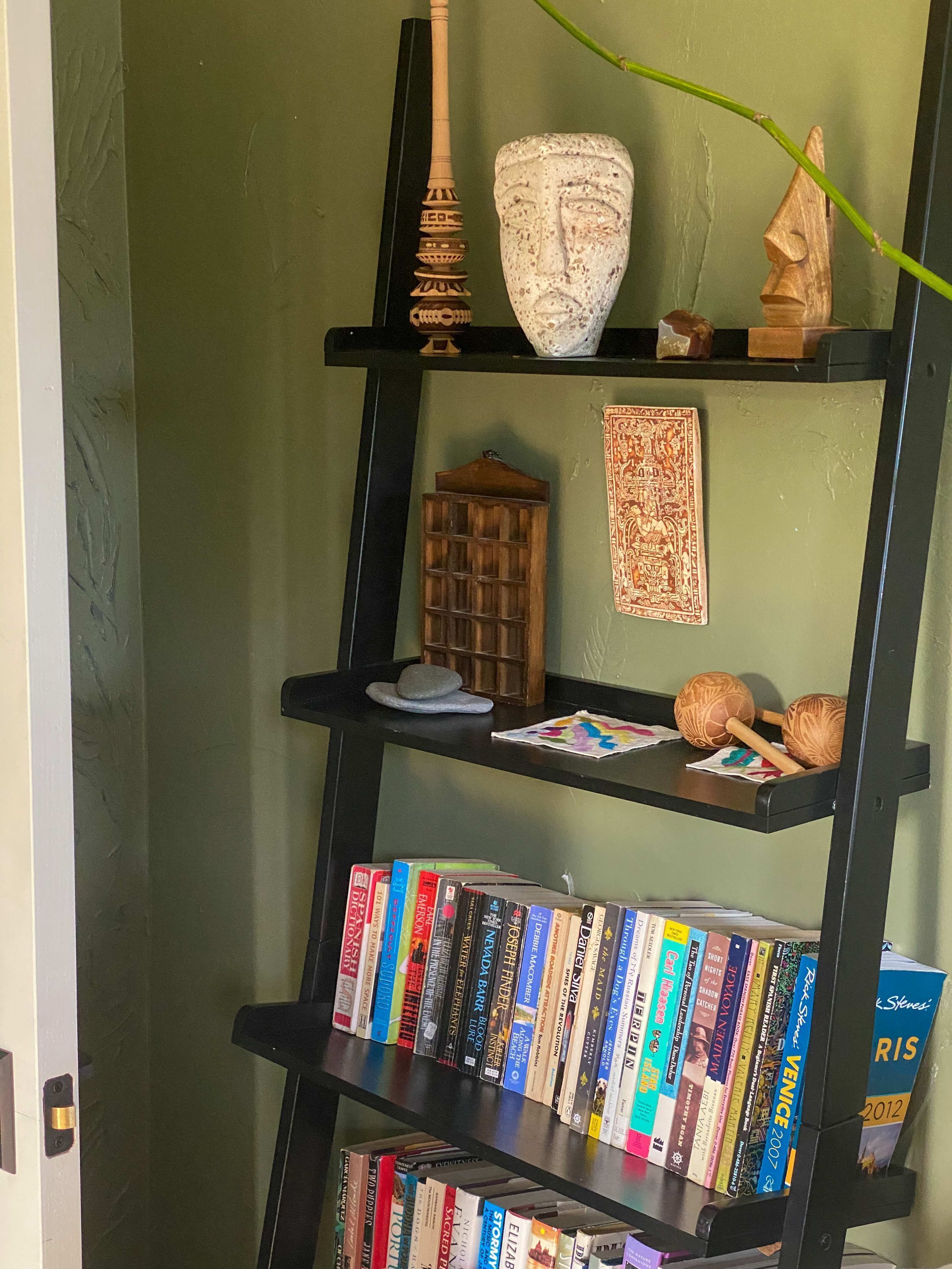 A bookshelf with various books and decorative items.