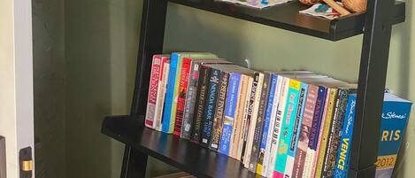A bookshelf with various books and decorative items.