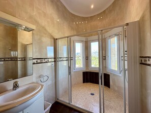 A bathroom with a glass-enclosed shower, a sink, and a mirror. - Casa Luna - Three Bedroom Villa With Stunning View (Orba)