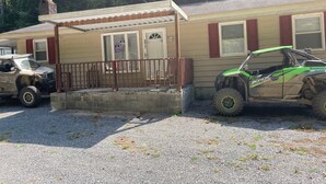 A small, single-story building with a porch and a garage.