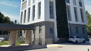 A modern building with a white facade and a vertical garden feature.