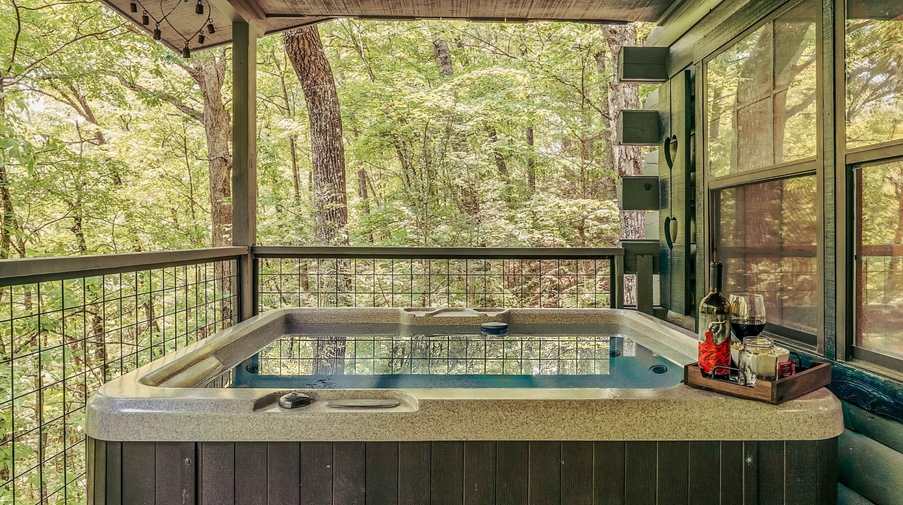 A hot tub with a view of a forest.