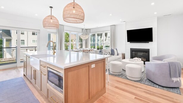 A modern kitchen with a large island, wooden cabinets, and pendant lighting. - Stareway to Heaven in Fairfield (Fairfield)